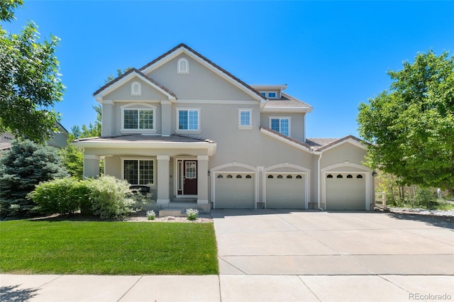 view of front facade featuring a front yard and a garage