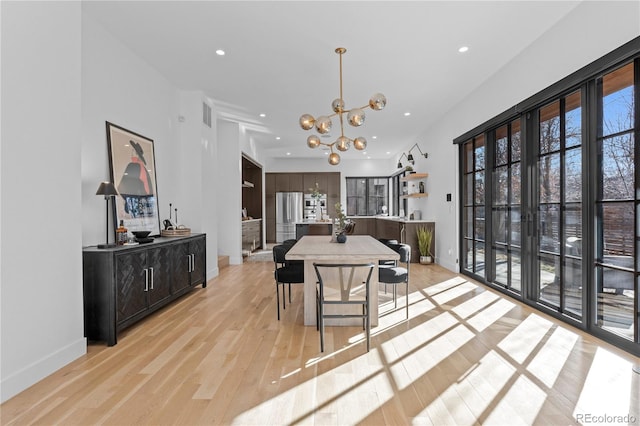 dining area featuring a chandelier and light wood-type flooring