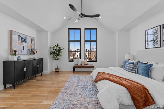 bedroom featuring vaulted ceiling, ceiling fan, and light wood-type flooring