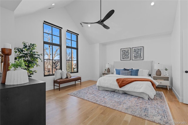 bedroom with high vaulted ceiling, light hardwood / wood-style floors, and ceiling fan