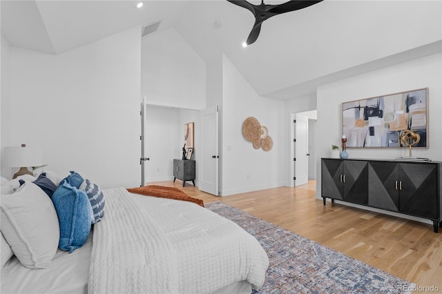 bedroom featuring ceiling fan, high vaulted ceiling, and hardwood / wood-style floors