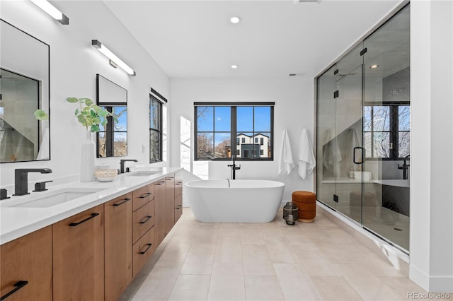 bathroom featuring vanity, tile patterned floors, and separate shower and tub