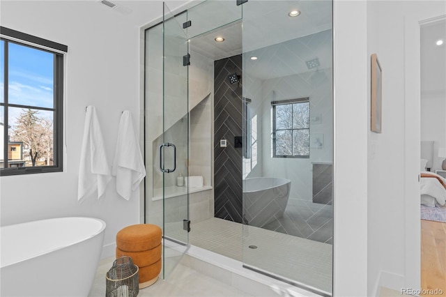 bathroom featuring plus walk in shower and tile patterned flooring