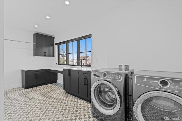 clothes washing area with cabinets, separate washer and dryer, and sink