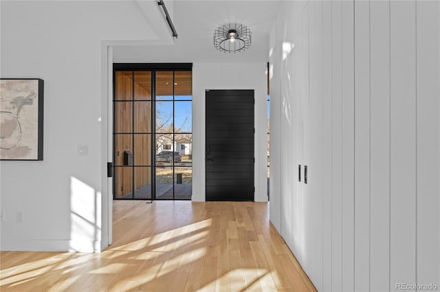 doorway to outside featuring expansive windows and light hardwood / wood-style floors