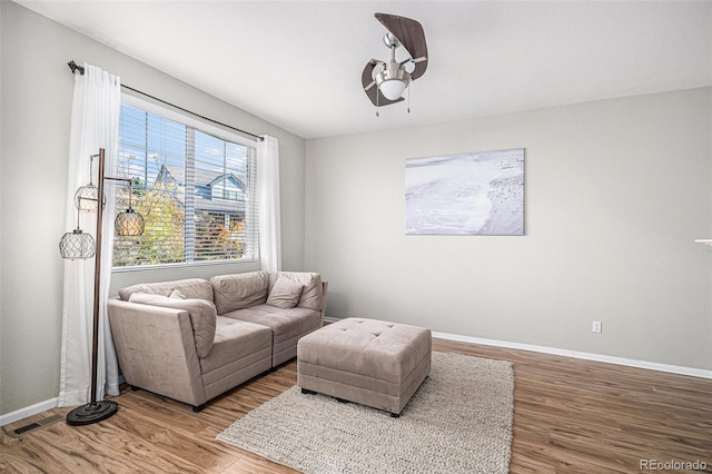 living room featuring hardwood / wood-style flooring and ceiling fan