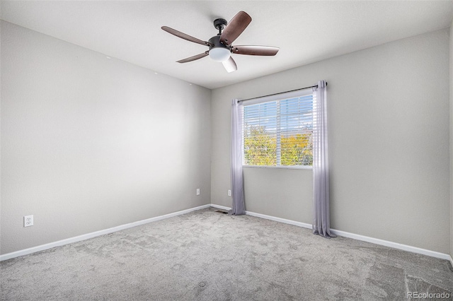 carpeted spare room featuring ceiling fan