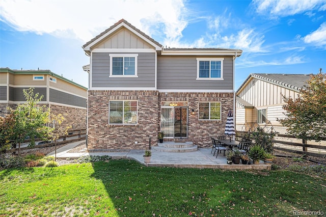 rear view of house with a patio area and a lawn