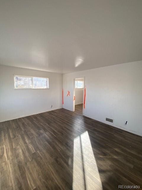 unfurnished room featuring dark hardwood / wood-style floors