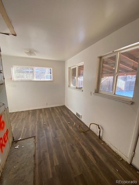 spare room featuring dark wood-type flooring