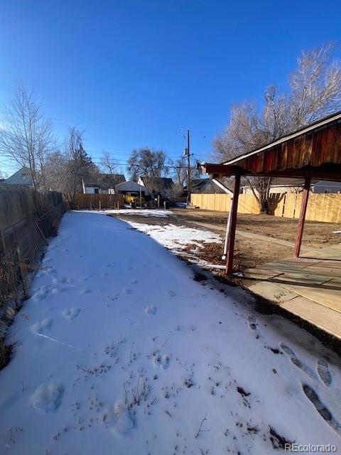 view of yard layered in snow