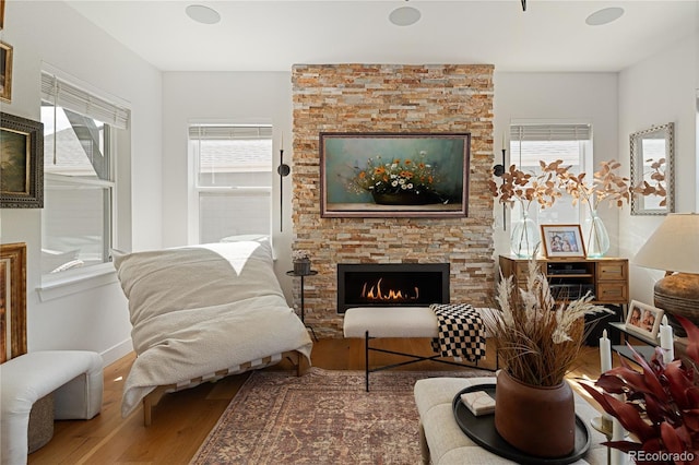 2855 Pawnee Creek Dr, Loveland, CO 80538 - living area with a fireplace, wood finished floors, and healthy amount of natural light