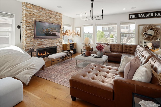 2855 Pawnee Creek Dr, Loveland, CO 80538 - living room featuring a chandelier, wood finished floors, a fireplace, and recessed lighting