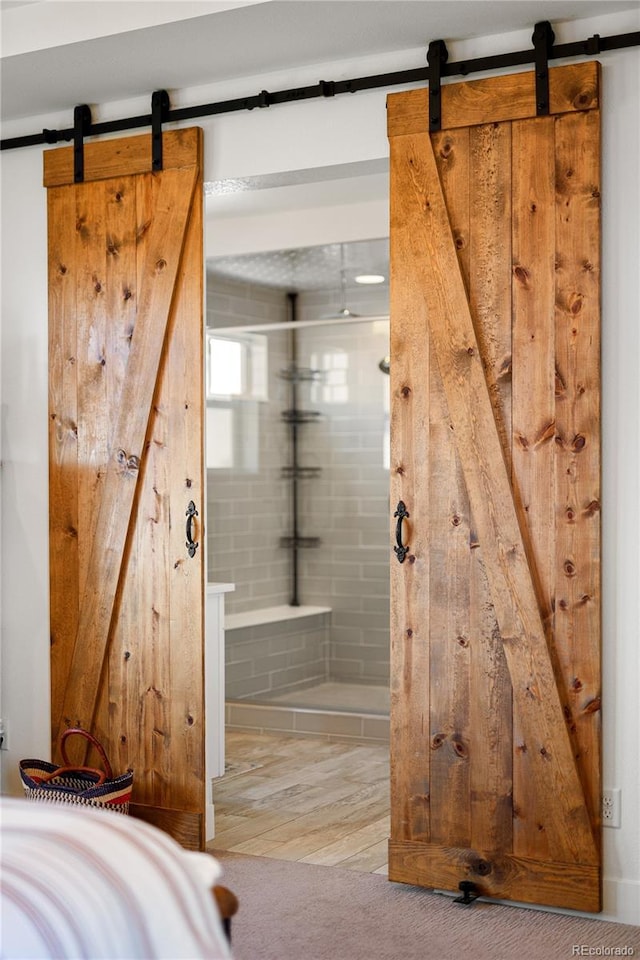 2855 Pawnee Creek Dr, Loveland, CO 80538 - bathroom featuring wood finished floors and walk in shower