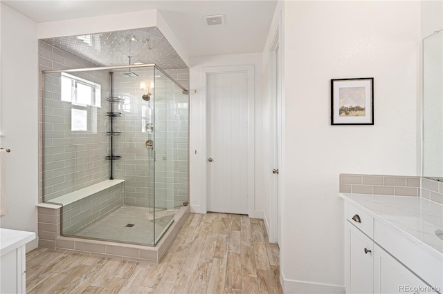 2855 Pawnee Creek Dr, Loveland, CO 80538 - bathroom featuring vanity, a shower stall, and wood finished floors