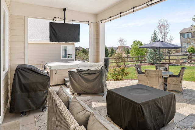 2855 Pawnee Creek Dr, Loveland, CO 80538 - view of patio featuring outdoor dining area, a hot tub, grilling area, and outdoor lounge area