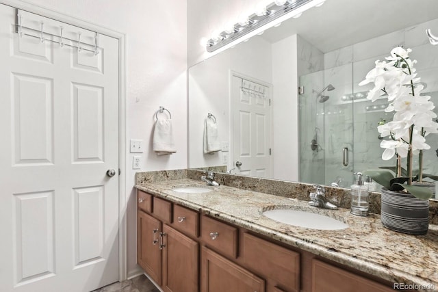 bathroom with double vanity, a stall shower, and a sink