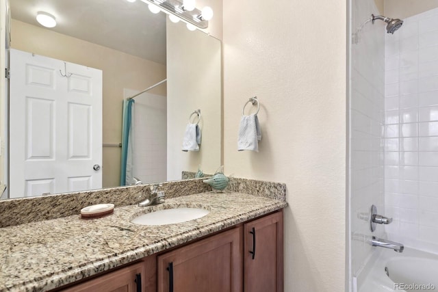 bathroom featuring shower / bath combo and vanity