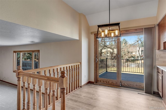 2631 Yorkshire St, Fort Collins, CO 80526 - unfurnished dining area with a chandelier, vaulted ceiling, and light wood finished floors