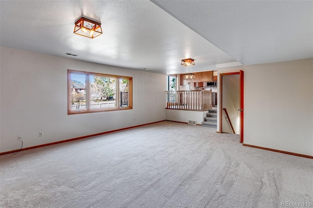 2631 Yorkshire St, Fort Collins, CO 80526 - spare room with light carpet, stairs, and a textured ceiling