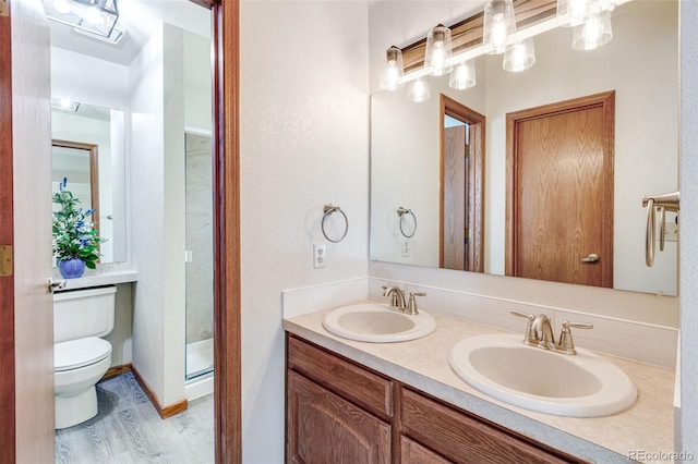 2631 Yorkshire St, Fort Collins, CO 80526 - bathroom with double vanity, wood finished floors, and a shower stall