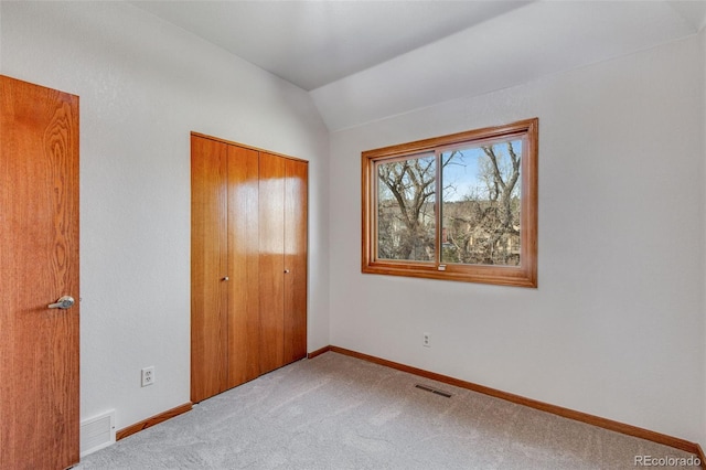 2631 Yorkshire St, Fort Collins, CO 80526 - unfurnished bedroom with a closet, vaulted ceiling, and carpet
