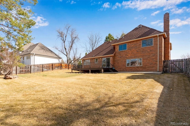 2631 Yorkshire St, Fort Collins, CO 80526 - back of house with a chimney, a deck, a fenced backyard, a gate, and brick siding