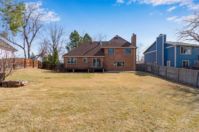 2631 Yorkshire St, Fort Collins, CO 80526 - back of property with a wooden deck, a fenced backyard, a chimney, and brick siding
