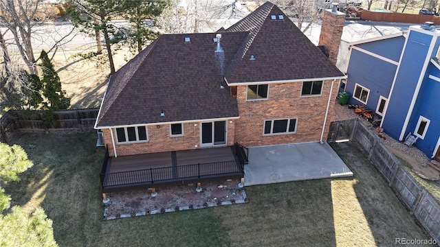 2631 Yorkshire St, Fort Collins, CO 80526 - rear view of house with brick siding, a shingled roof, a chimney, and a fenced backyard