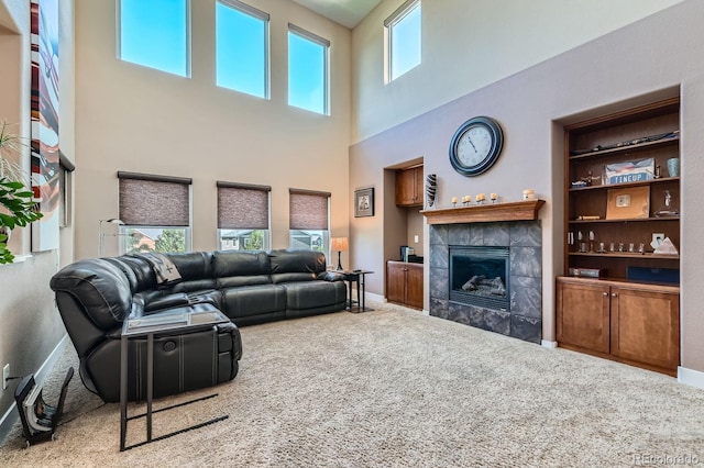 14179 Madison St, Thornton, CO 80602 - carpeted living room featuring a tiled fireplace and a towering ceiling