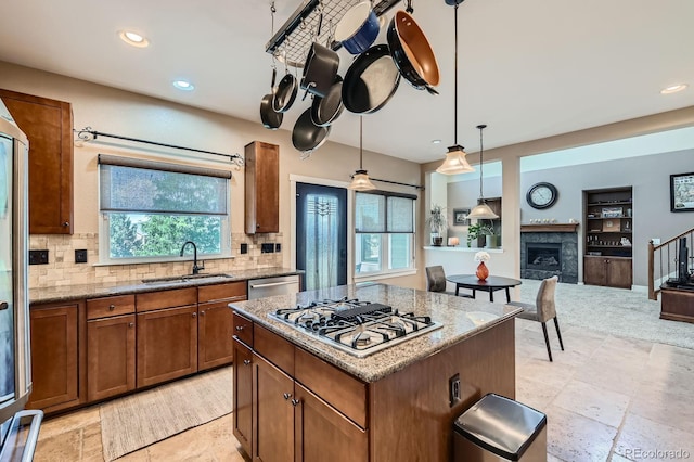14179 Madison St, Thornton, CO 80602 - kitchen with stainless steel appliances, brown cabinets, backsplash, recessed lighting, and light stone countertops