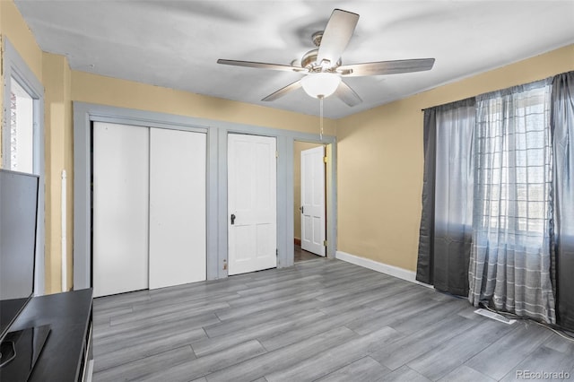 48 Elm St, Arriba, CO 80804 - unfurnished bedroom with multiple windows, light hardwood / wood-style floors, and ceiling fan