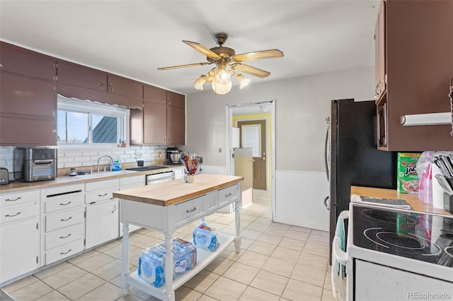48 Elm St, Arriba, CO 80804 - kitchen featuring white cabinetry, sink, light tile patterned floors, and white range with electric cooktop