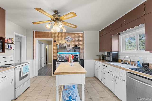 48 Elm St, Arriba, CO 80804 - kitchen with white electric stove, sink, stainless steel dishwasher, light tile patterned floors, and ceiling fan
