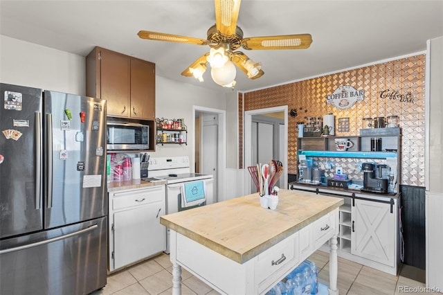 48 Elm St, Arriba, CO 80804 - kitchen with white cabinetry, ceiling fan, stainless steel appliances, and light tile patterned floors