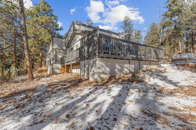 snow covered property featuring a deck