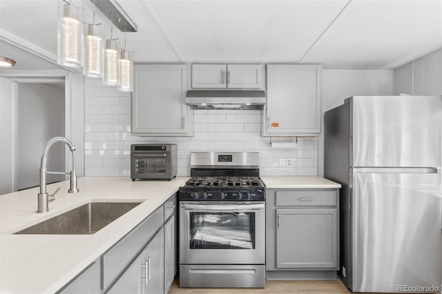177 Gray St, Bailey, CO 80421 - kitchen featuring stainless steel appliances, under cabinet range hood, gray cabinetry, and backsplash