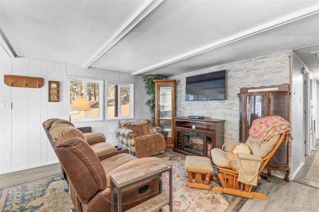 177 Gray St, Bailey, CO 80421 - living area featuring wood finished floors, beam ceiling, and a textured ceiling