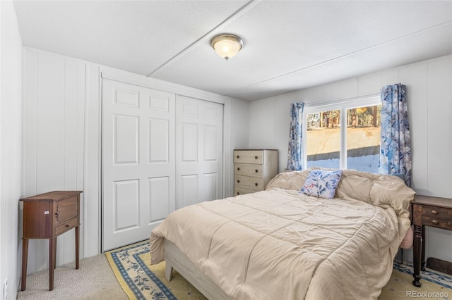 177 Gray St, Bailey, CO 80421 - bedroom with light colored carpet, a decorative wall, a closet, and access to exterior