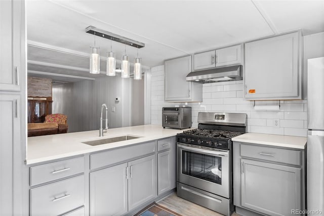 177 Gray St, Bailey, CO 80421 - kitchen featuring appliances with stainless steel finishes, under cabinet range hood, gray cabinets, light countertops, and decorative light fixtures