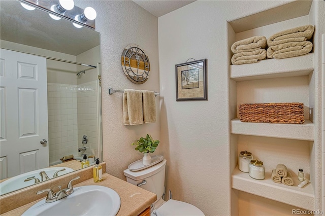 full bathroom featuring a textured wall, vanity, toilet, and shower / bathtub combination