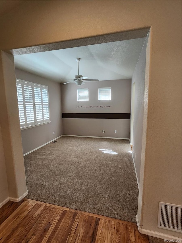 221 Homestead Pkwy, Longmont, CO 80504 - empty room with a ceiling fan, carpet, and wood finished floors