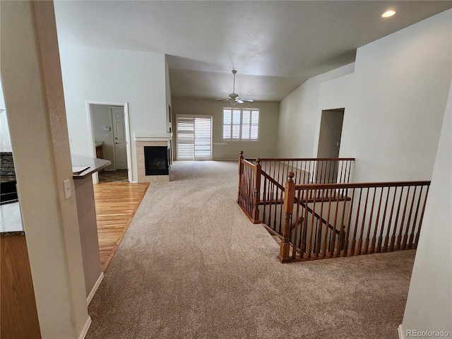 221 Homestead Pkwy, Longmont, CO 80504 - corridor featuring an upstairs landing, light carpet, light wood-style flooring, and vaulted ceiling