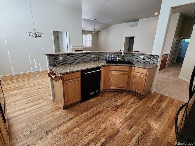 221 Homestead Pkwy, Longmont, CO 80504 - kitchen featuring dishwasher, dark stone counters, tasteful backsplash, light wood-style flooring, and a ceiling fan