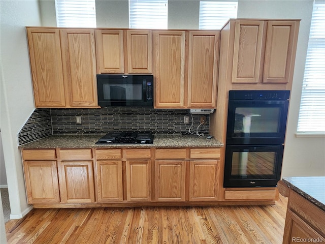 221 Homestead Pkwy, Longmont, CO 80504 - kitchen featuring black appliances, tasteful backsplash, light wood finished floors, and light brown cabinetry