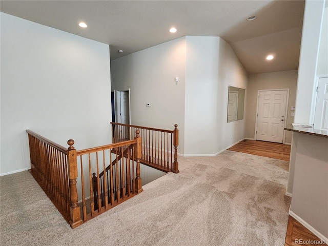 221 Homestead Pkwy, Longmont, CO 80504 - hallway with an upstairs landing, carpet, recessed lighting, and vaulted ceiling