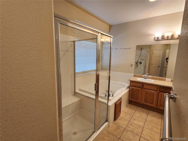 221 Homestead Pkwy, Longmont, CO 80504 - full bathroom featuring a tub with jets, a shower stall, a textured wall, vanity, and tile patterned floors