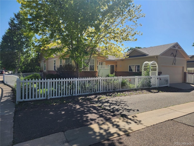 221 Homestead Pkwy, Longmont, CO 80504 - view of front of home featuring an attached garage, a fenced front yard, and concrete driveway
