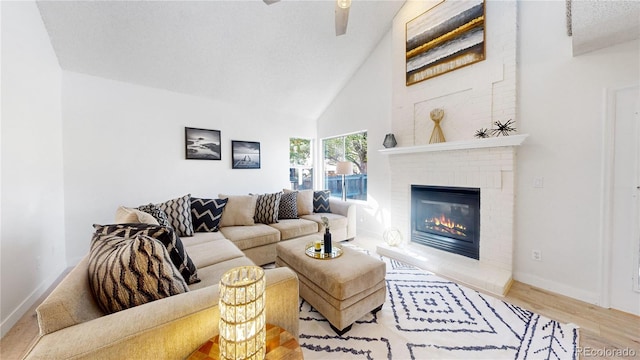 living room featuring a textured ceiling, hardwood / wood-style floors, vaulted ceiling, and a brick fireplace