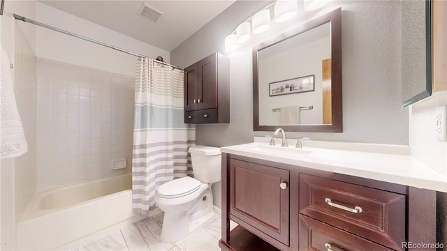 full bathroom featuring shower / bath combo, vanity, and toilet